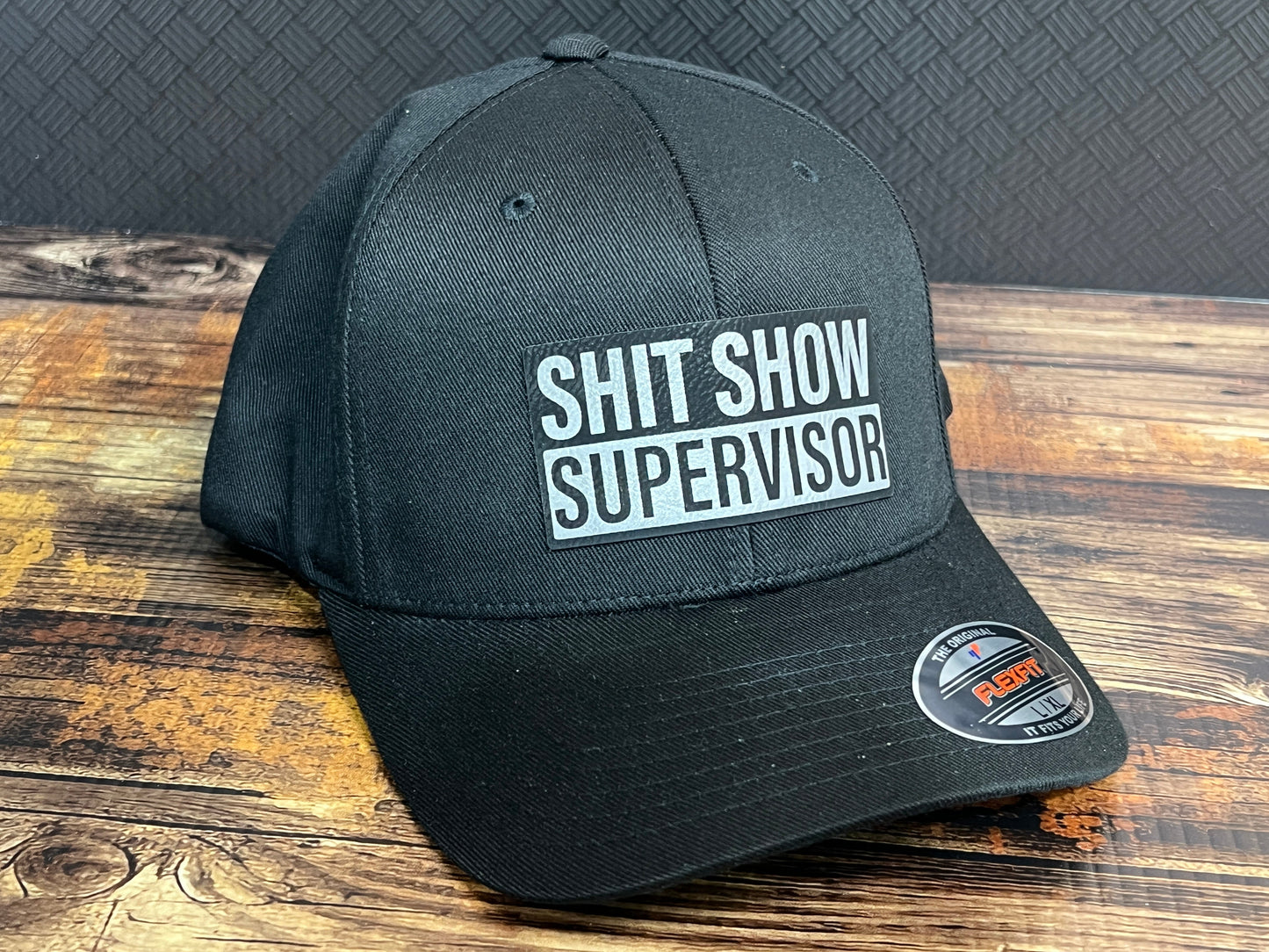Shit Show Supervisor Hat with Premium Leatherette Patch on a Flexfit Patch Hat