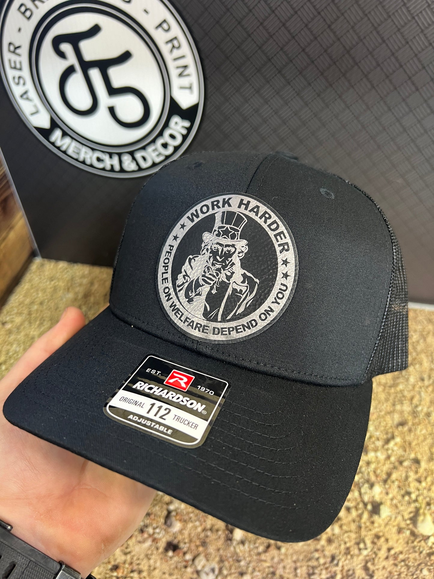 Work Harder Hat Design with a Premium Leatherette Patch on a Richardson 112 Trucker Hat for Conservative Americans.