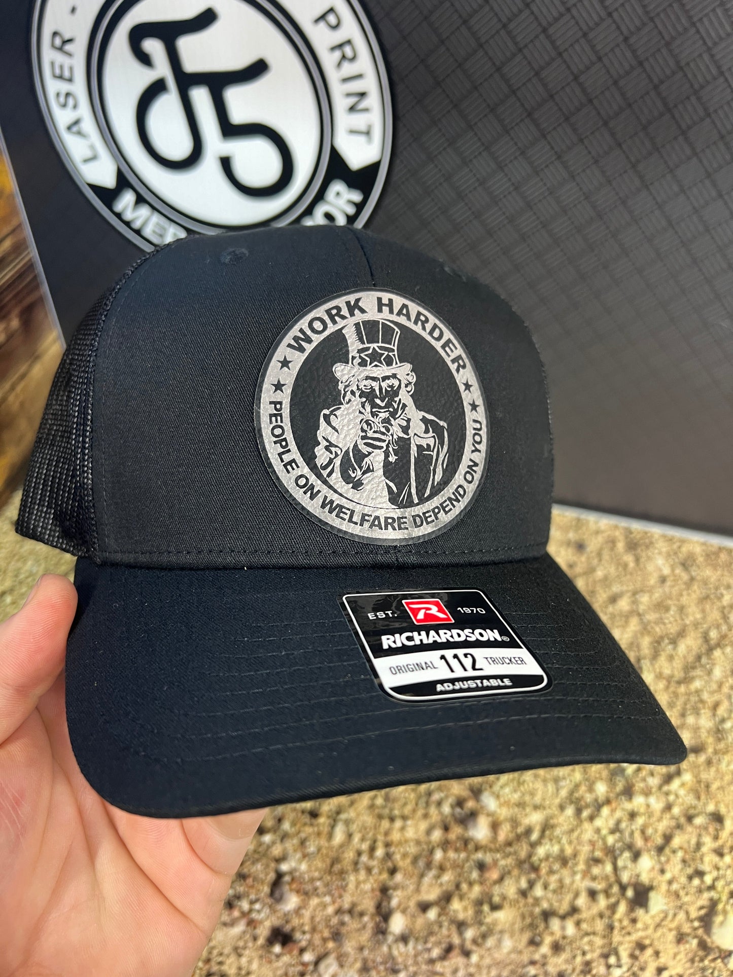 Work Harder Hat Design with a Premium Leatherette Patch on a Richardson 112 Trucker Hat for Conservative Americans.