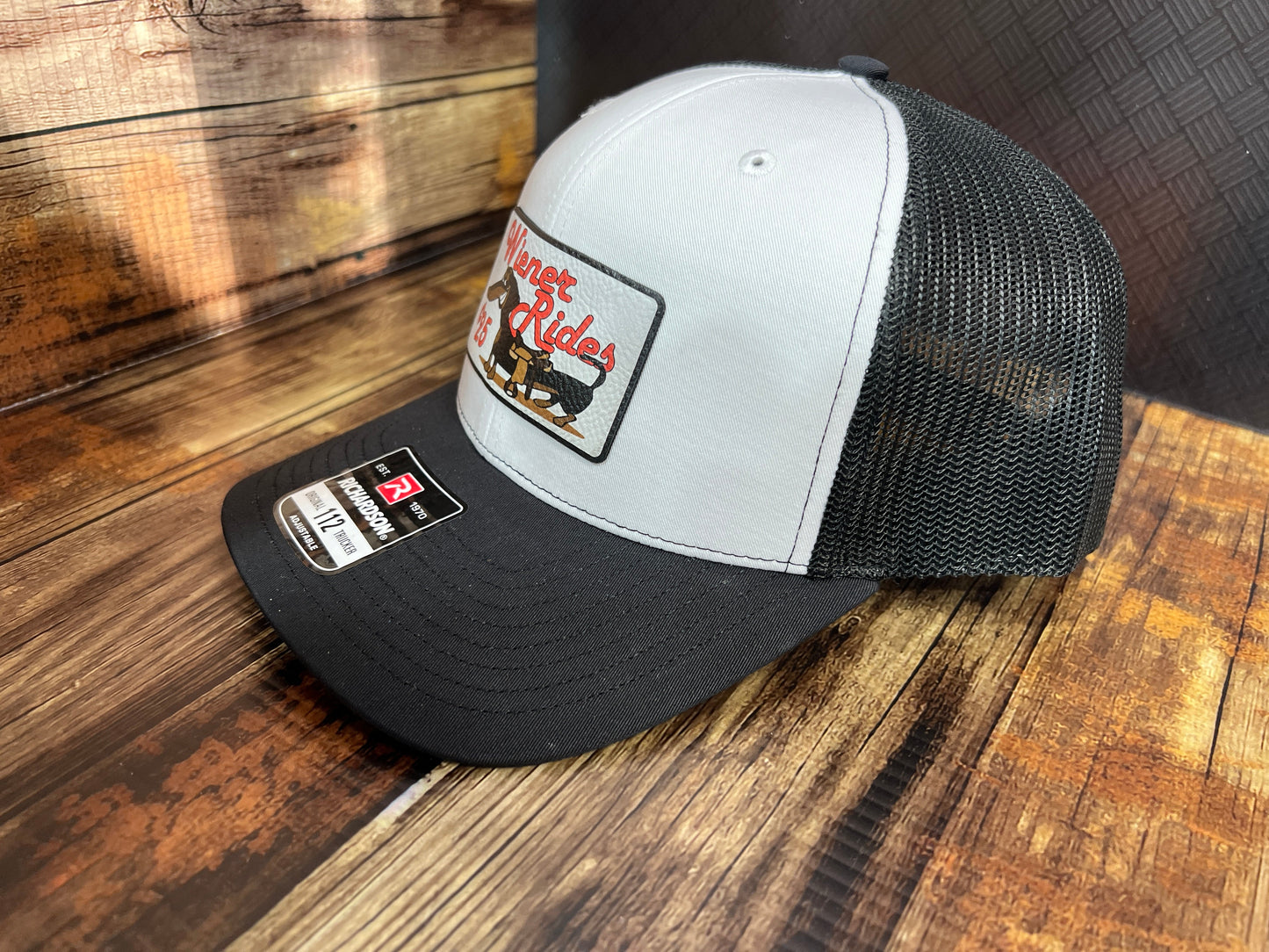 Wiener Rides Patch Hat with a UV Printed Premium Leatherette Patch on a Richardson 112 Trucker Hat